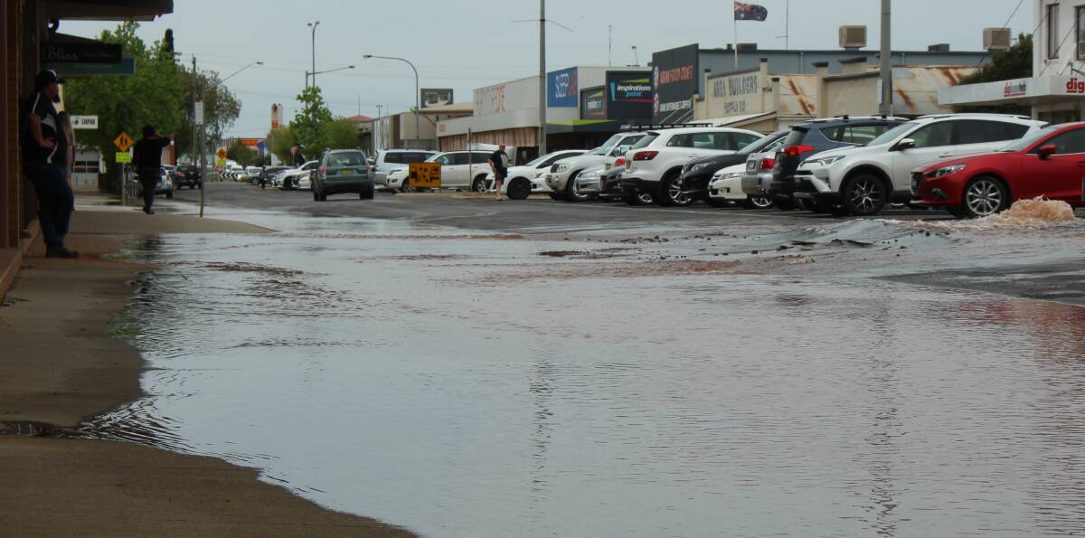 BURST: ​The burst pipe ripped through the tarred surface of Yambil Street on Friday afternoon, surprising motorists and business owners in the area.