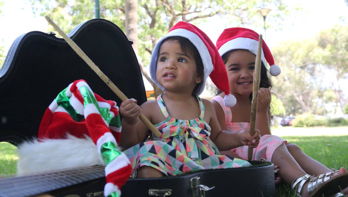 CAROLS: Merecedes Loseli (4) and Sia Loseli (1) enjoying traditional Christmas carols at the spectacular event recently held in Griffith.
