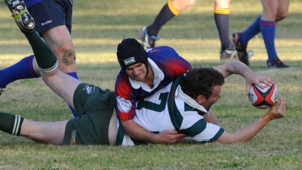 RIVALS NO MORE: Former Young player Jared Maxwell scores a good try despite strong defence from Temora's Nathan Philp. 