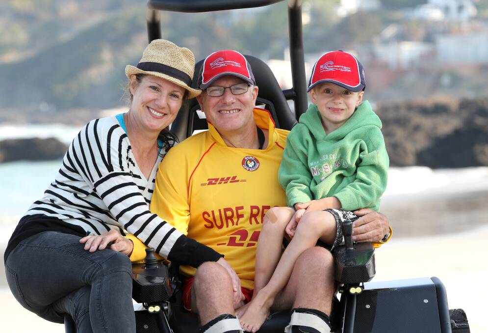 Family: Kirk Dicker, diagnosed with MND in 2014, does beach patrols in an all-terrain wheelchair with his son Anthony and partner Joanna Sharp.