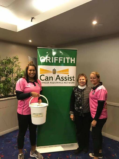 GENEROSITY: Makelesi Toga and Shailyn Williams from the Black and Whites league tag side with CanAssist's Olga Forner during their Pink Day event.