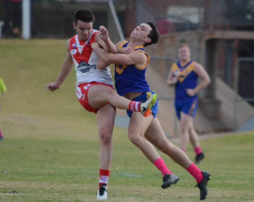 HARD HIT: Swans' Luke Shannon bumped by a Narrandera defender during last weekend's big win over the Eagles. PHOTO: Liam Warren