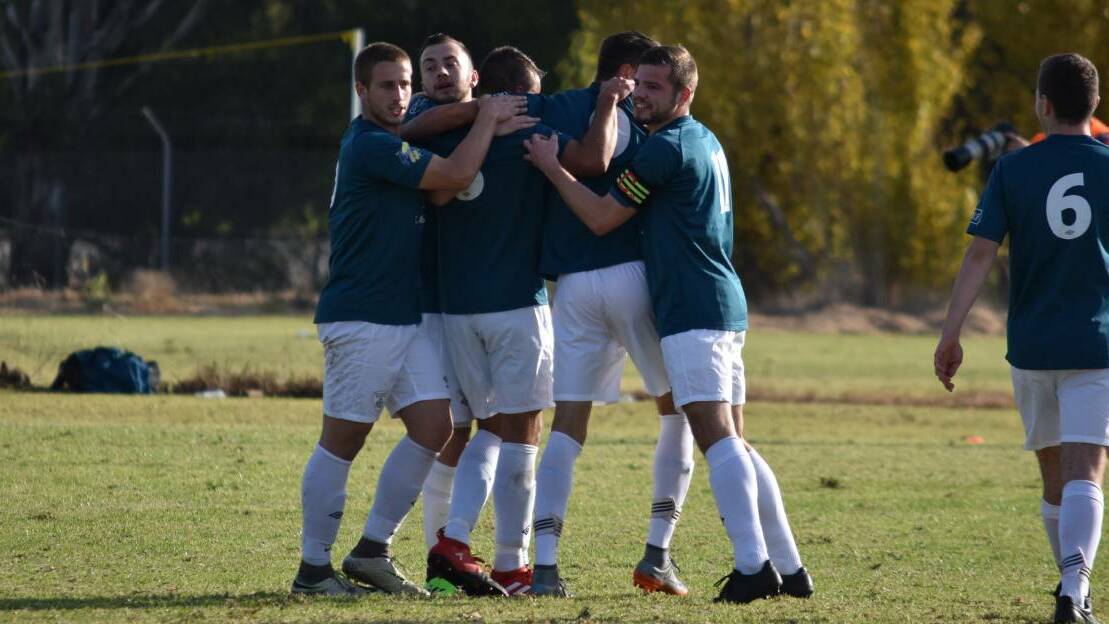CELEBRATIONS: Riverina Rhinos players congratulate themselves following their 2-0 win over Weston Molonglo last weekend. PHOTO: Ben Jaffrey