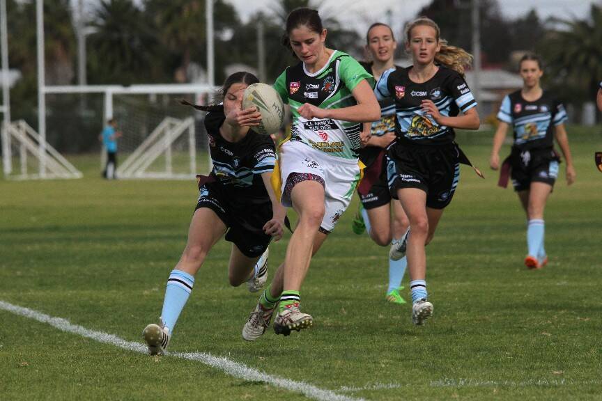 DOMINANT: Leeton's Anna Poulsen attempts to evade the defence.