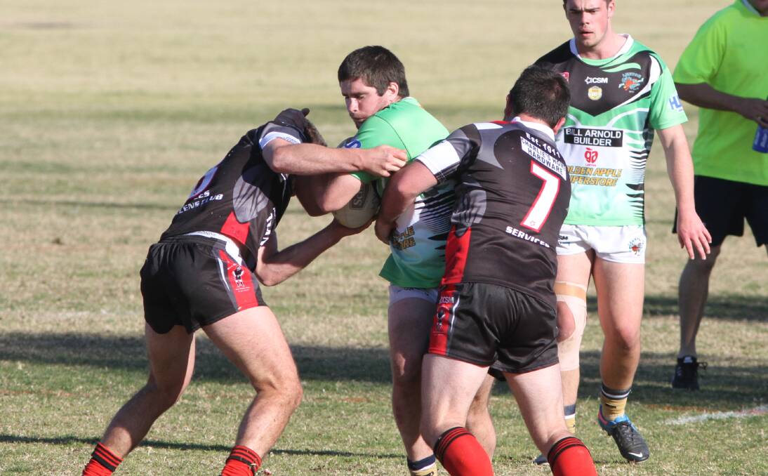 WRAPPED UP: Leeton’s Jaryd Pattison tries to make his way through the West Wyalong defence during last weekend’s game. Photo: Talia Pattison