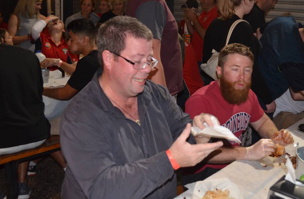 David Warren from the Area Hotel team wipes away the sweat caused by the intensity of the hot wings
