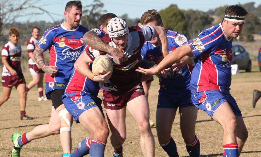 HELP UP: Yanco-Wamoon's Codey Parsons tries to make his way through the Darlington Point-Coleambally defence on Sunday. Photo: Anthony Stipo