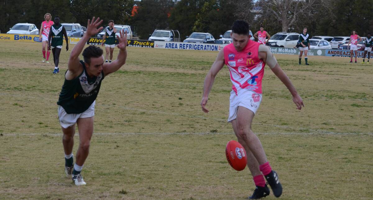 MAN ON: Swans' Reece Matheson tries to get a kick away before he is smothered by the oncoming Coolamon defenders. PHOTO: Liam Warren