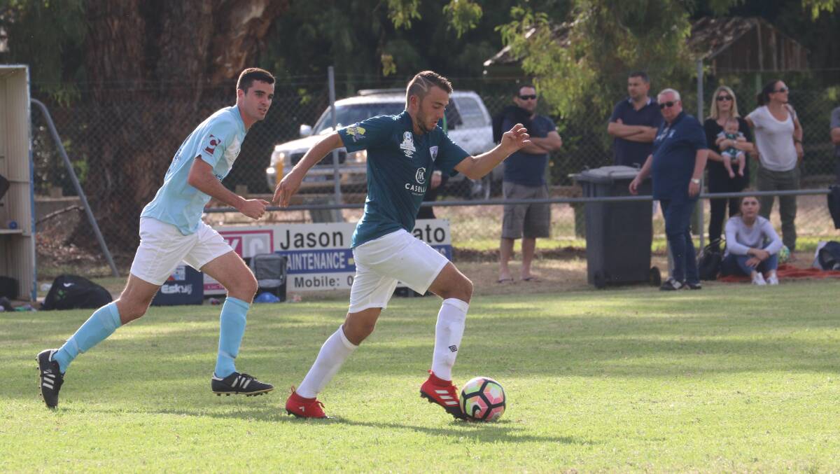 MOVING DOWNFIELD: Joseph Preece looks to get the Rhinos on the front foot in their tough game against Belconnen United in the National Premier League. PHOTO: Anthony Stipo