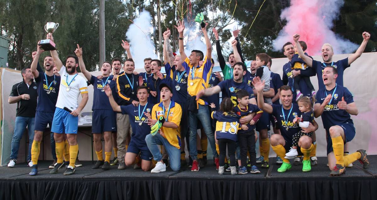 Winners are grinners: Yoogali SC celebrate their grand final victory over arch rivals Hanwood FC. Picture: Anthony Stipo