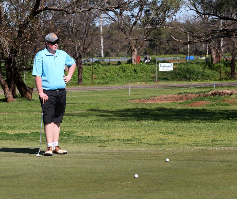 SUNSHINE AND SPORT: Daniel Richards checks out the competition on the Griffith golf course recently on a rare sunny day. Picture: Anthony Stipo
