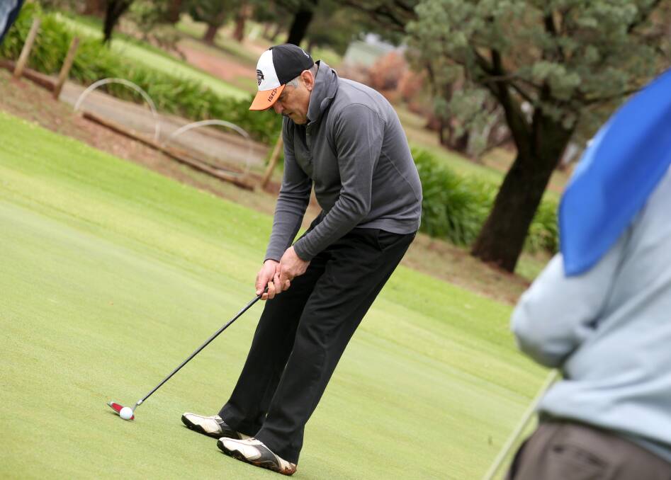 STEADY HANDS: Alan Le Broque is a picture of concentration at the Griffith Golf Club on Saturday. Picture: Anthony Stipo