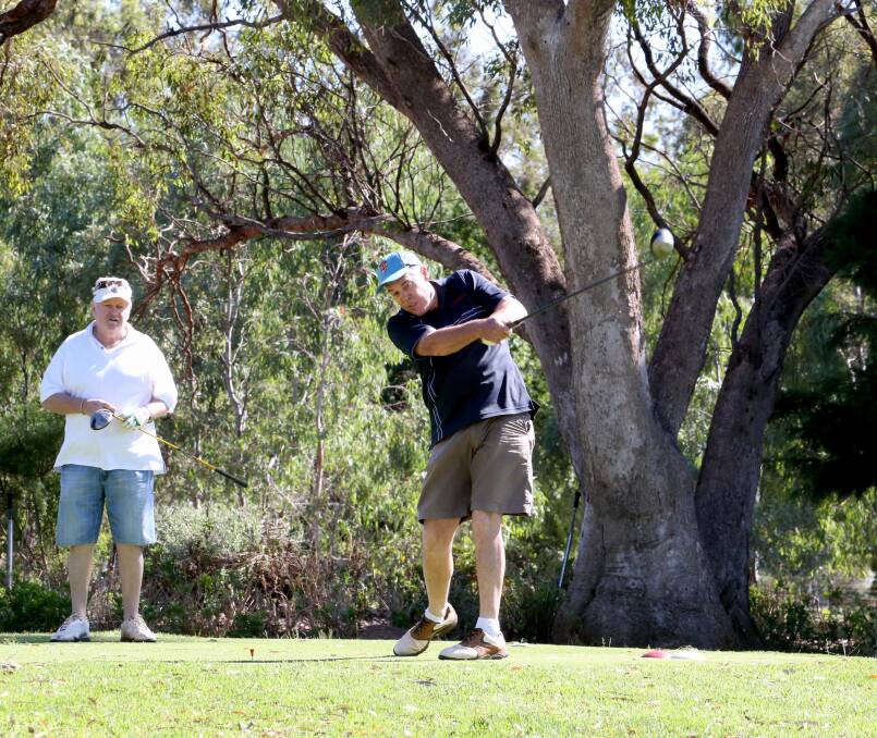 CONCENTRATION: Mark Webb lines up a shot under the watchful eye of a fellow golfer at the Griffith Golf Club at the weekend. Picture: Anthony Stipo