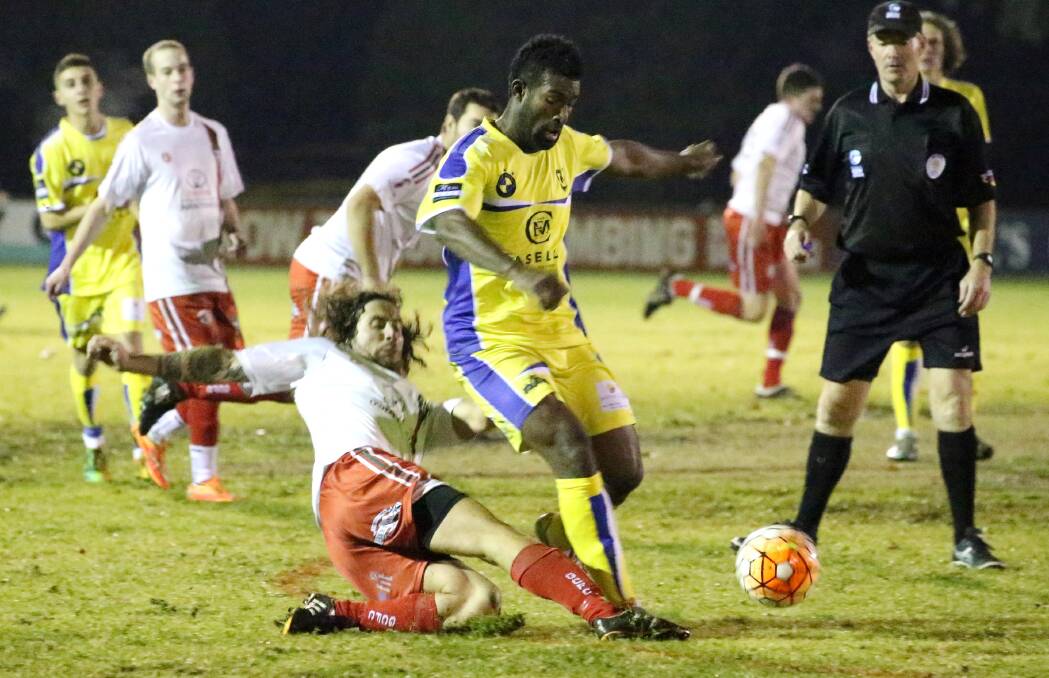 OFF THE DUCK: Griffith City's Joel McClure and Yoogali FC's Uraia Loki battles it out all night, but it was Loki who came out the victor. Picture: Anthony Stipo. 