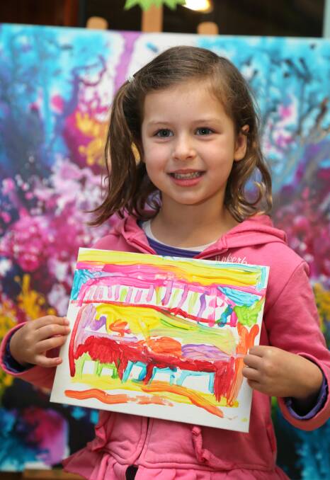 INSPIRED: Laura Tarbit from Dorothy Waide Centre for Early Learning shows off her painting of a house in Nepal. Picture: Anthony Stipo
