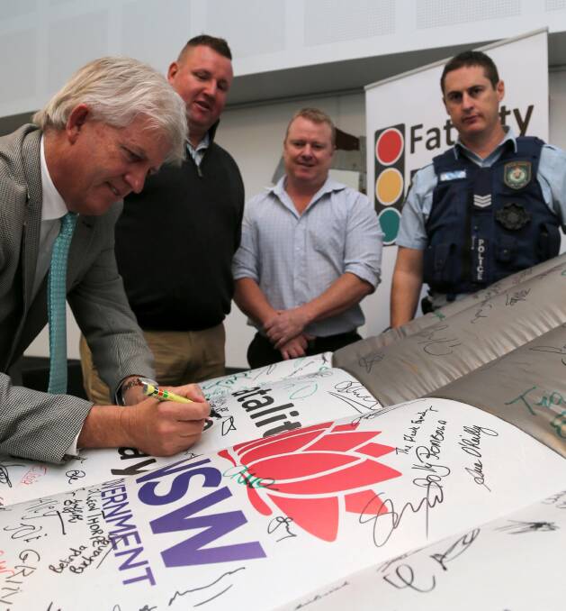 SIGNING THE PLEDGE: Brett Stonestreet, Doug Curran, Greg Balind and Colin Lonsdale from Griffith Highway Patrol making a pledge to drive safely. Picture: Anthony Stipo.