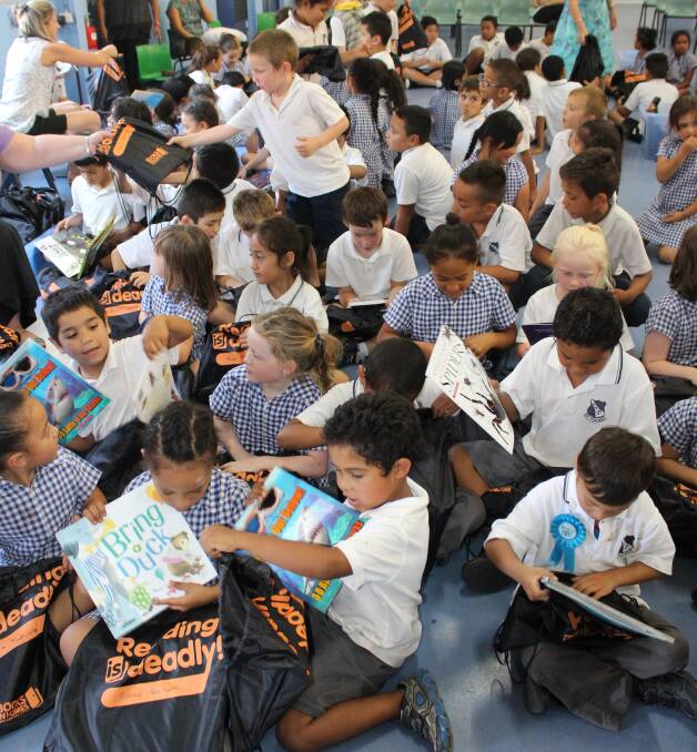 KNOWLEDGE: Kids from Griffith Public School excited as they discover which books they've been given this time around. Picture: Riley Krause.