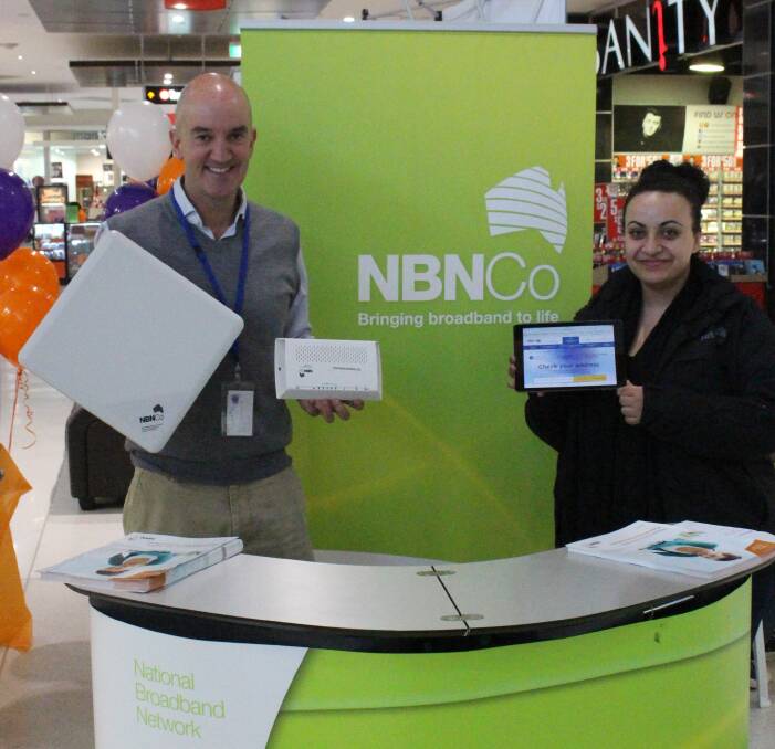 QUICK INTERNET: Fixed wireless community affairs advisors Tony Gibbs and Amy Jaballah answering people's questions at Griffith Central on Thursday. Picture: Riley Krause.