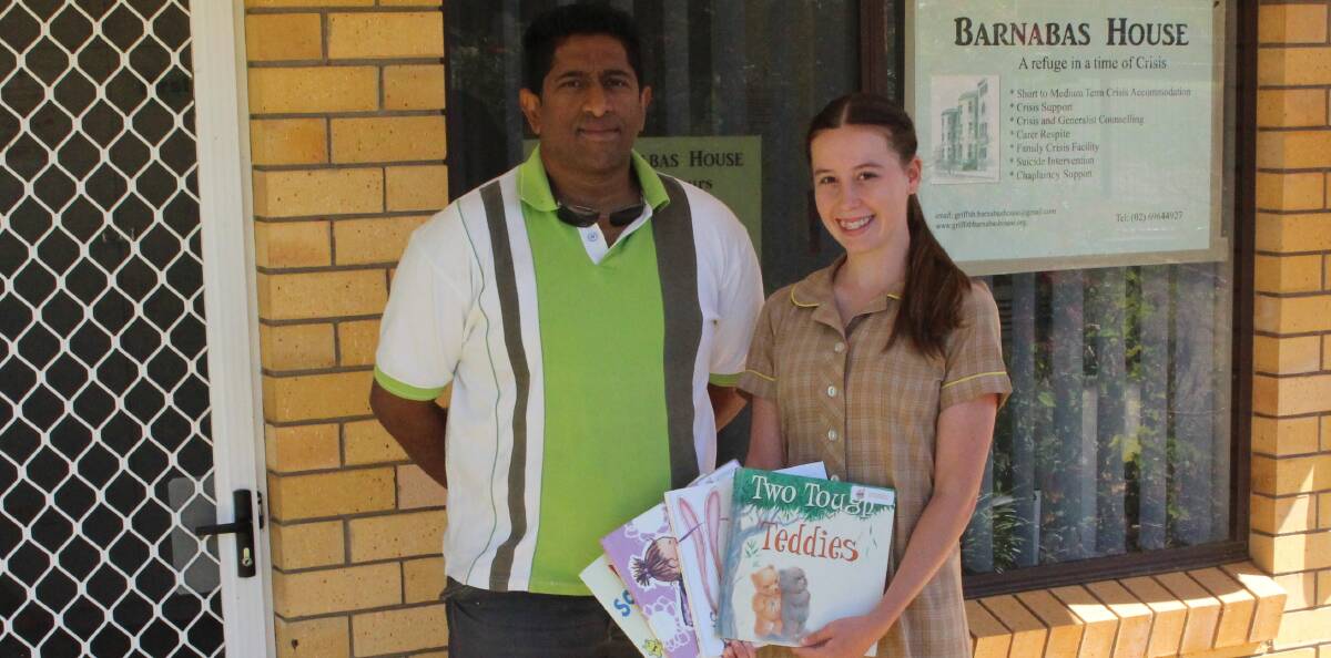 WONDREFUL: Felix Sebastian was delighted to receive the donation of books collected by Annalise Bellicanta. Picture: Riley Krause.