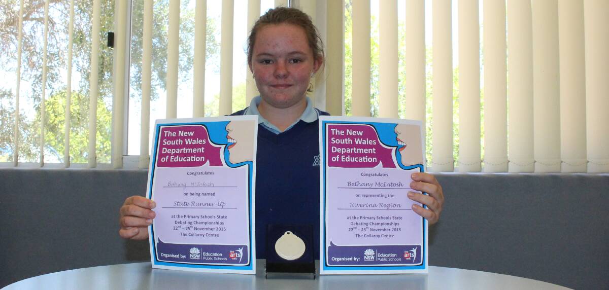 GREAT JOB: Bethany McIntosh shows off her awards from representing the Riverina at a state debating competition. Picture: Riley Krause