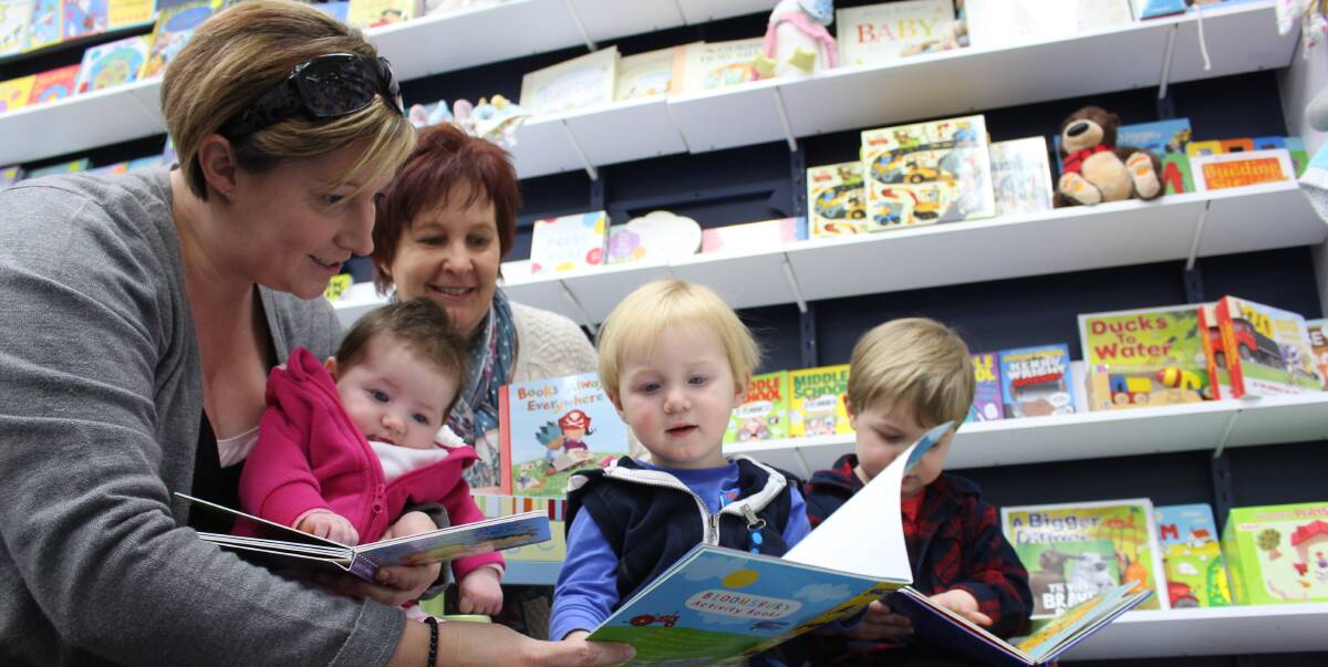 QUIET TIME: Rebecca (front), Kelsey, Alec and Jake Lashbrook enjoying the thrills of reading while store owner Debbie Guertin (back) looks on. Picture: Riley Krause.