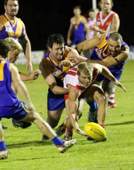 TRAFFIC: Swans player Ben King fights his way through to the Sherrin against Narrandera. Picture: Anthony Stipo