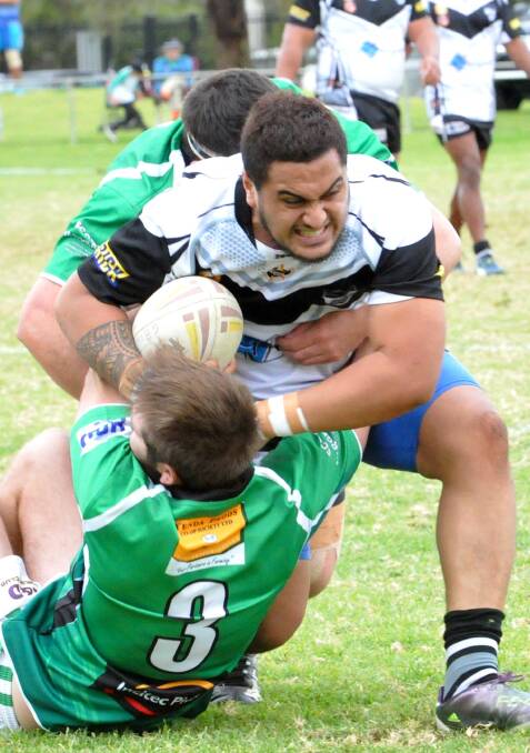 STRIVING: Griffith Black and Whites player Sonny Tupu tries to fight off the Leeton defenders at EW Moore Oval. Picture: Wendy Simpkin