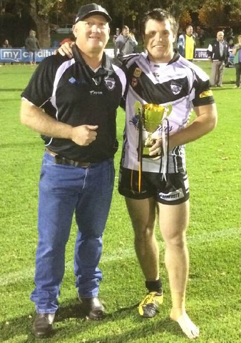 WINNING COMBINATION:  Griffith Black and White Panthers co-coaches Craig Morriss (left) and David Milne with the Joe Fabris Memorial Cup. Picture: Supplied