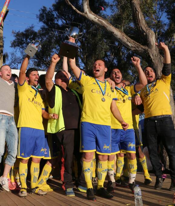 Good times: Yoogali FC celebrate last season's grand final win over Hanwood FC. Picture: Anthony Stipo