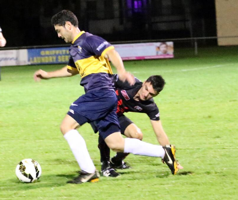 EVASIVE: Yoogali SC's Joe Crisafulli blows past Leeton United's Luke Mandaglio in the Billabong Cup clash at EW Moore Oval. Picture: Anthony Stipo