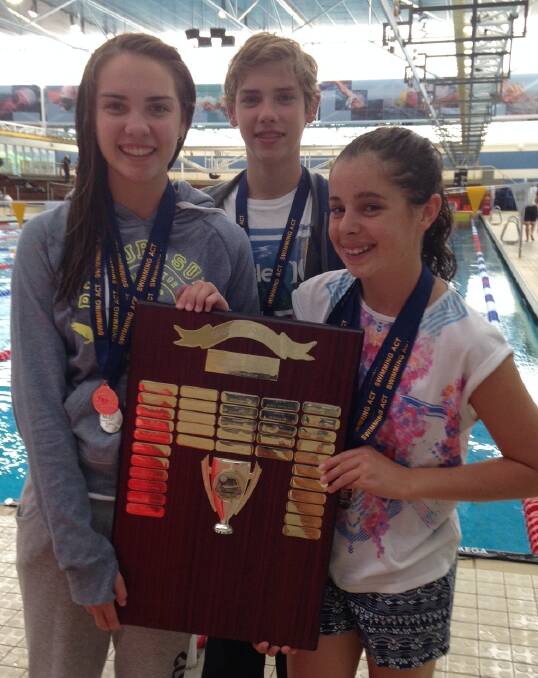 REWARDED: Griffith swimmers Erin Golden, Joshua Golden and Morgan Twigg with the James Brophy Memorial Trophy they helped Riverina win. Picture: Supplied.