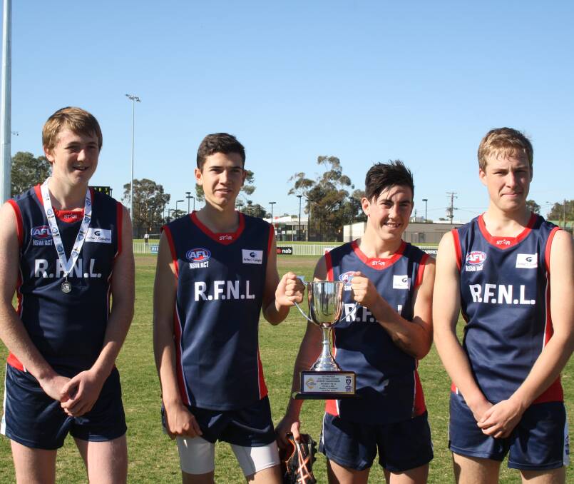 PROUD: Griffith Swans players Jacob Conlan, Brady Chambers, Angus Coldwell and Brady French with the spoils of victory after playing for Riverina. Picture: Supplied