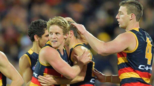 The Crows celebrate a goal in their match with Geelong, which saw them pull clear at the top of the ladder. Photo: AAP