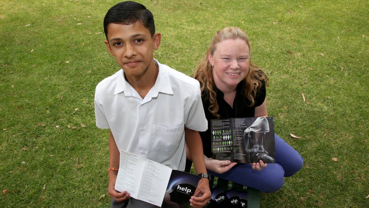 HELP: Harsh Rathi, 14, with Naomi Brugger at Griffith High School, showing off Harsh's youth mental health guide which is available across Griffith. Picture: Anthony Stipo.