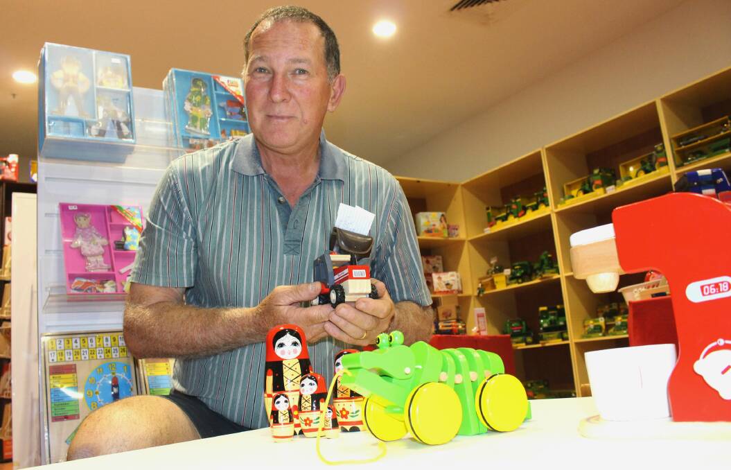 TOY STORY: Keith Russell from Keidra Woodworks with some of the wooden toys for sale at his pop-up shop in Griffith Central. Picture: Stephen Mudd.