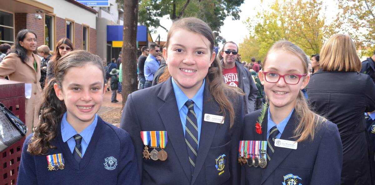 PROUD: Lexi Salvestro, 10, Isabella Smith,11, and Tess Woodhouse, 11, attend the service. Picture: Anthony Stipo