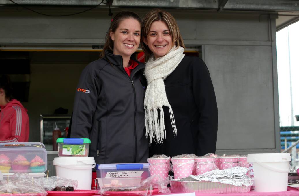 Caprice Gastin and Kylie Smith sell cakes as part of the fundraiser.