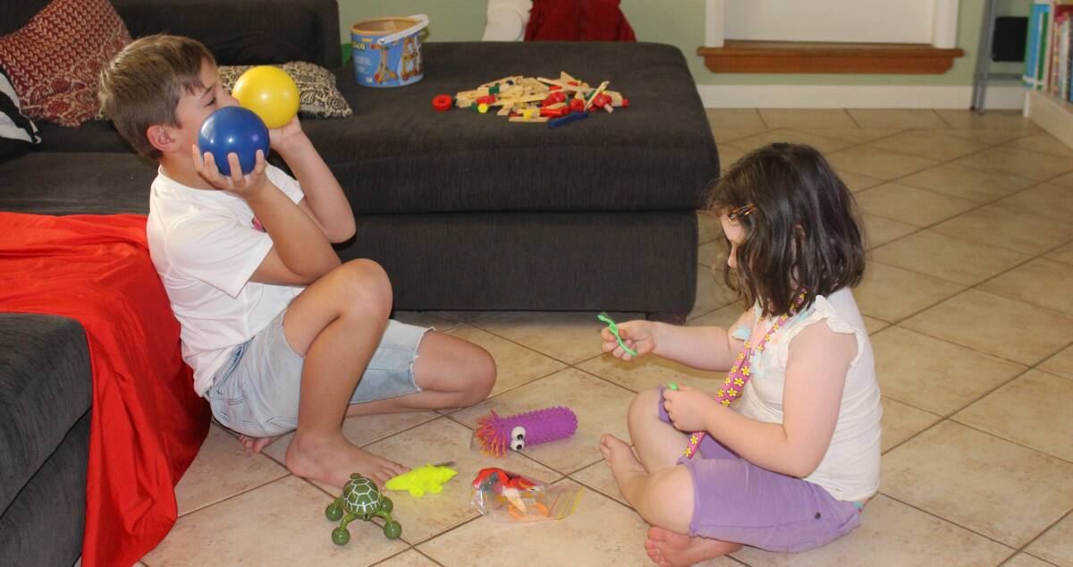 RAISING AWARENESS: Noah Beltrame and Zoey Frizell play with sensory toys designed for children with Autism Spectrum Disorder. These toys are useful tools for parents. Picture: Stephen Mudd