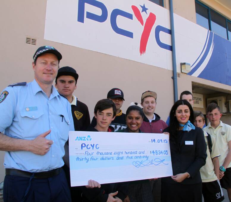 GRANT: Senior Constable Alex Davies is presented a cheque by Loretta Calabria from ANZ Bank to fund a financial literacy program at Griffith PCYC. Picture: Stephen Mudd.