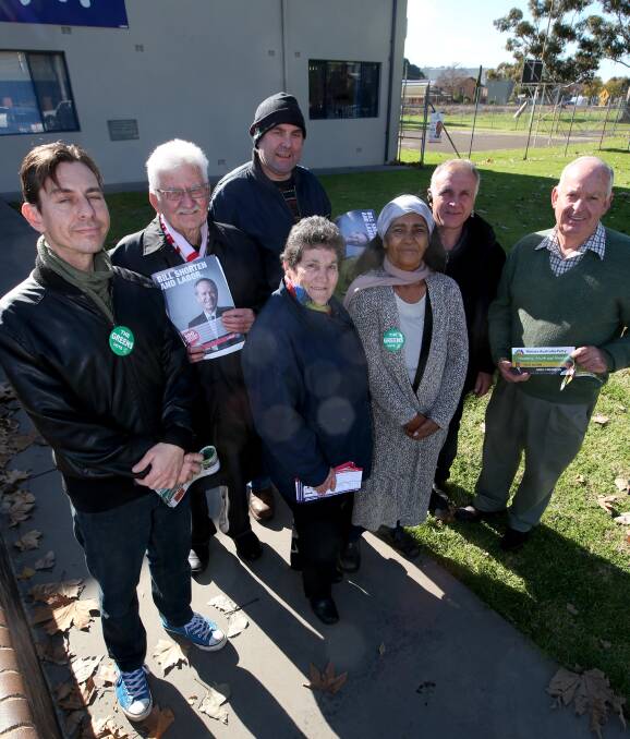 HAPPY DAYS: Election volunteers Jon Romeo, Peter Knox, Max Buljubasic, Fran Pietroboni, Veronica Collins, Frank Carbone and Trevor O'Brien hand out how-to-vote cards at Griffith PCYC. Picture: Anthony Stipo.