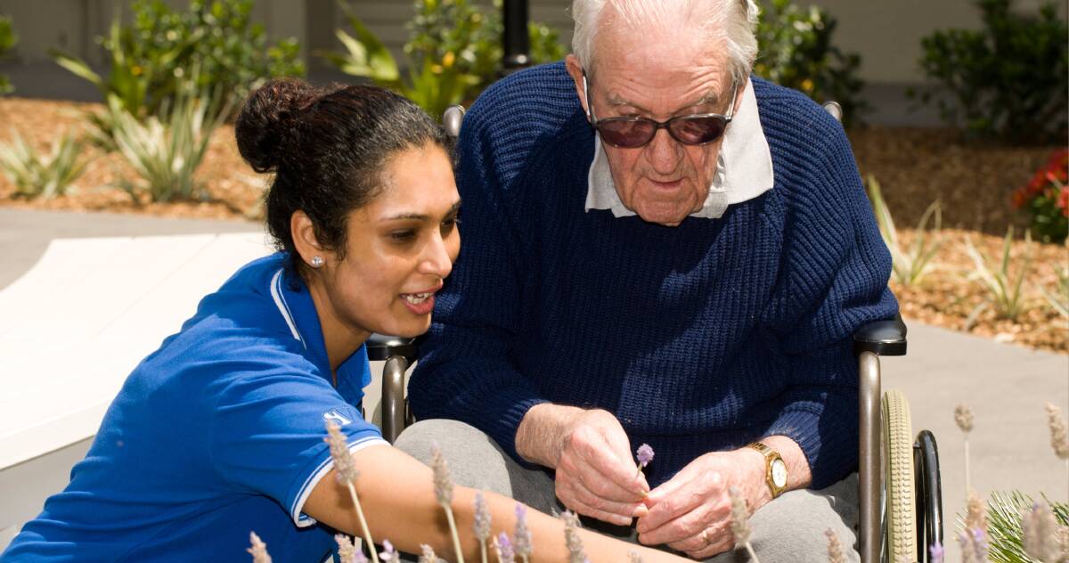HELPING HAND: Scalibrini Village's Sudeshni Mani with resident John Martin. Their approach for dementia sufferers was to create a safe, welcoming environment that felt like home. Picture: Supplied. 