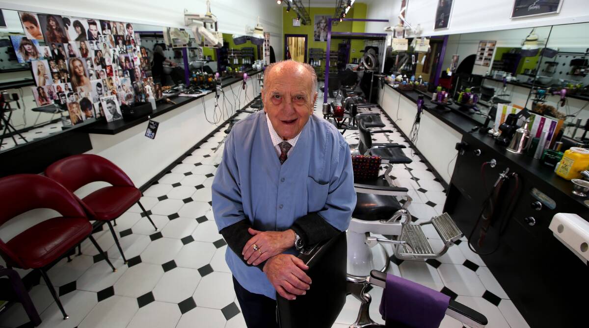STILL GOING: Tony Batagglia is still cutting hair nearly 60 years after he opened his business. He has no plans to retire. Picture: Anthony Stipo.