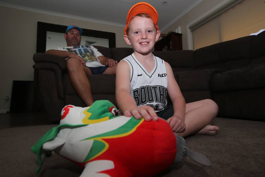 Bodhi Brady, 9, with his dad Shamus, are keen to see cheaper flights for Griffith. Photo: Anthony Stipo.