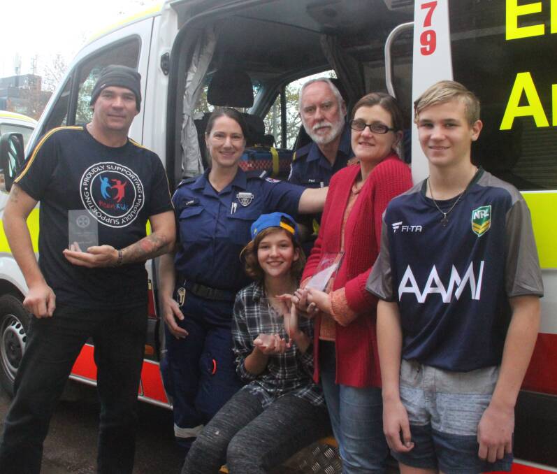 THANKFUL: Mark, Abbiey, Trish and Tysen Enness with paramedics Lindel Carey and Paul O'Brien at Griffith Ambulance Station on Thursday. Picture: Stephen Mudd.