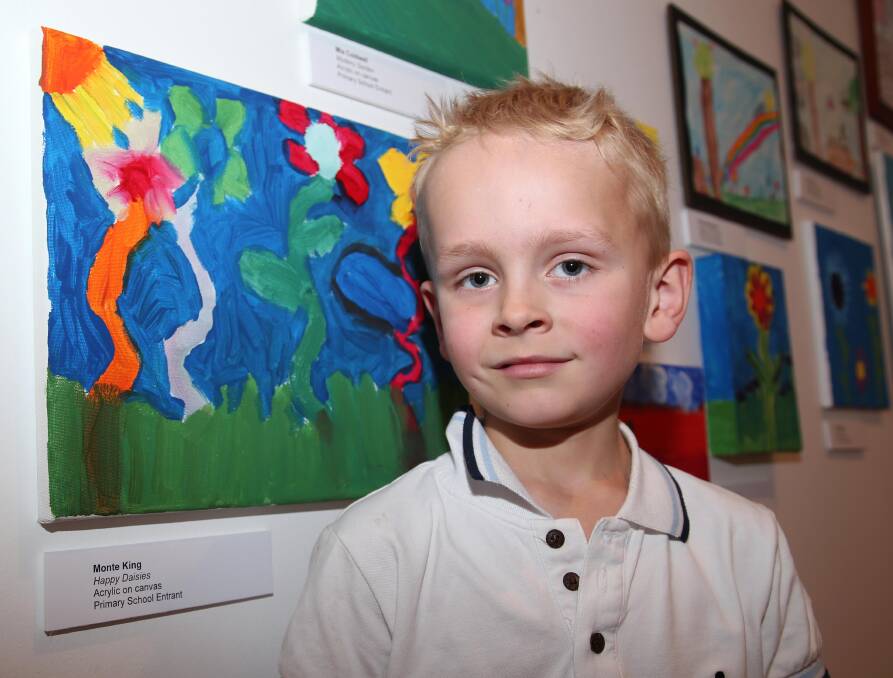 Monte King, 6, with his prize-winning artwork.