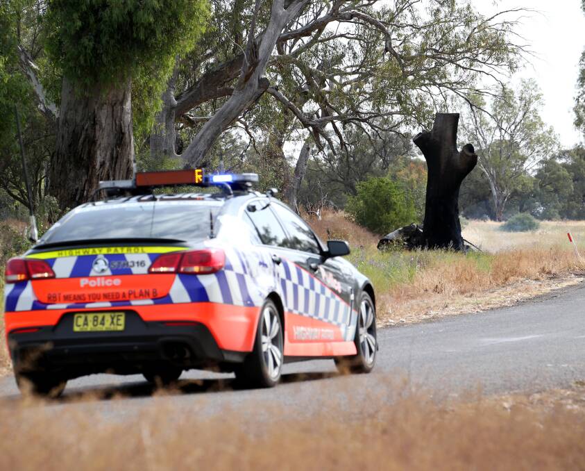CRASH: A car travelling along Murrumbidgee River Road crashed into a tree and was found in flames on Wednesday afternoon, according to police. The driver was found dead at the scene. Picture: Anthony Stipo.