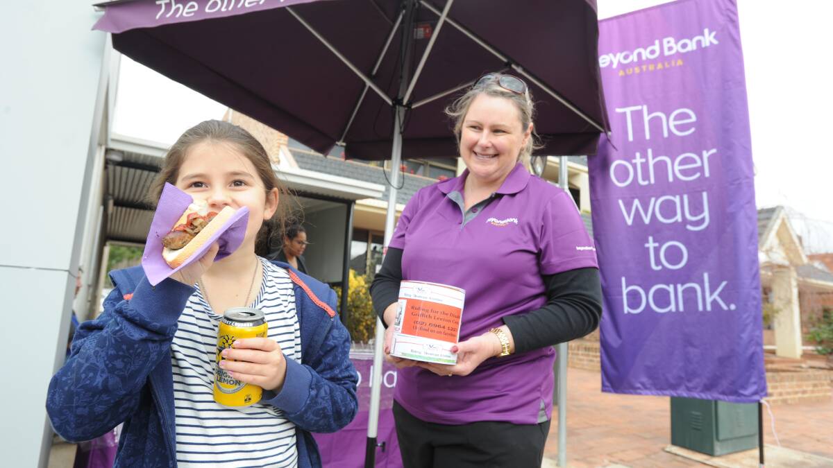 YUM: Sophie Aloisi, 8 and Allanah Hughes from Beyond Bank at the fundraising barbecue on Friday. Picture: Stephen Mudd.