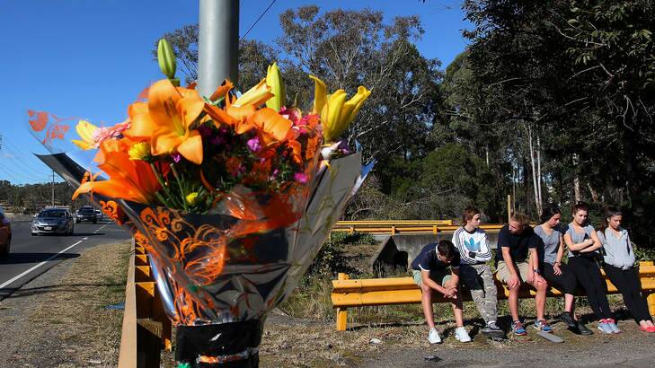 Shocked: Young friends gather at the crash site of Philip Vassallo on Andrews Road in Penrith. Photo: Lisa Maree Williams