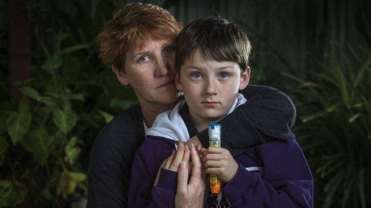 Dee Henderson with her son Aiden (9) who had a severe reaction after three sips of a coconut drink which contained cow's milk. Photo: ROSS SWANBOROUGH