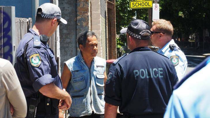 Van Ngo and police officers on Campbell Street in St Peters.  Photo: WestConnex Action Group